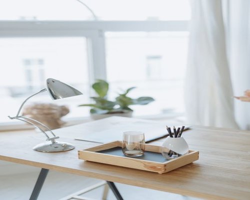 Organized work desk with water and natural light